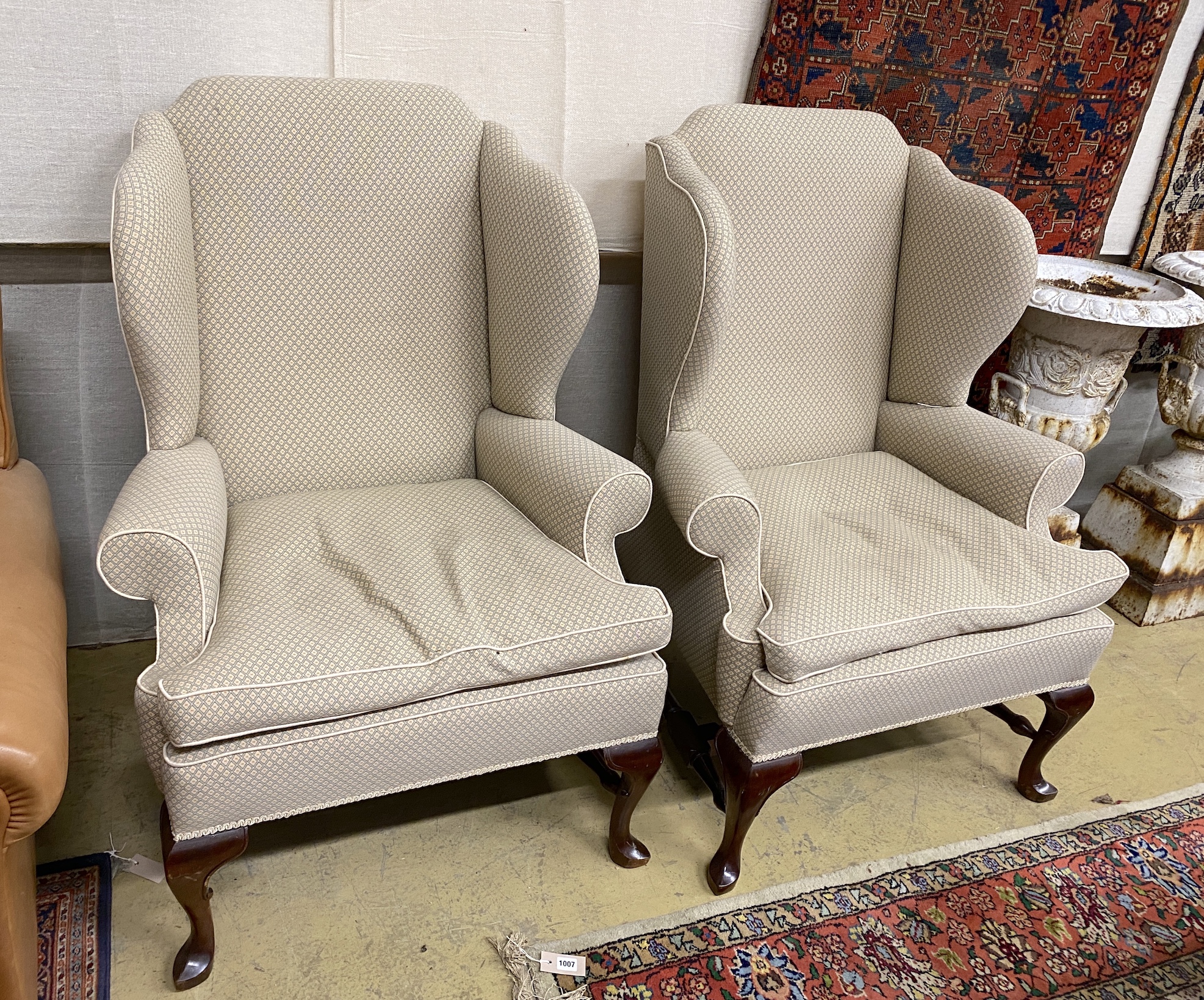 A good pair of George III style upholstered wing armchairs, width 84cm, depth 74cm, height 116cm